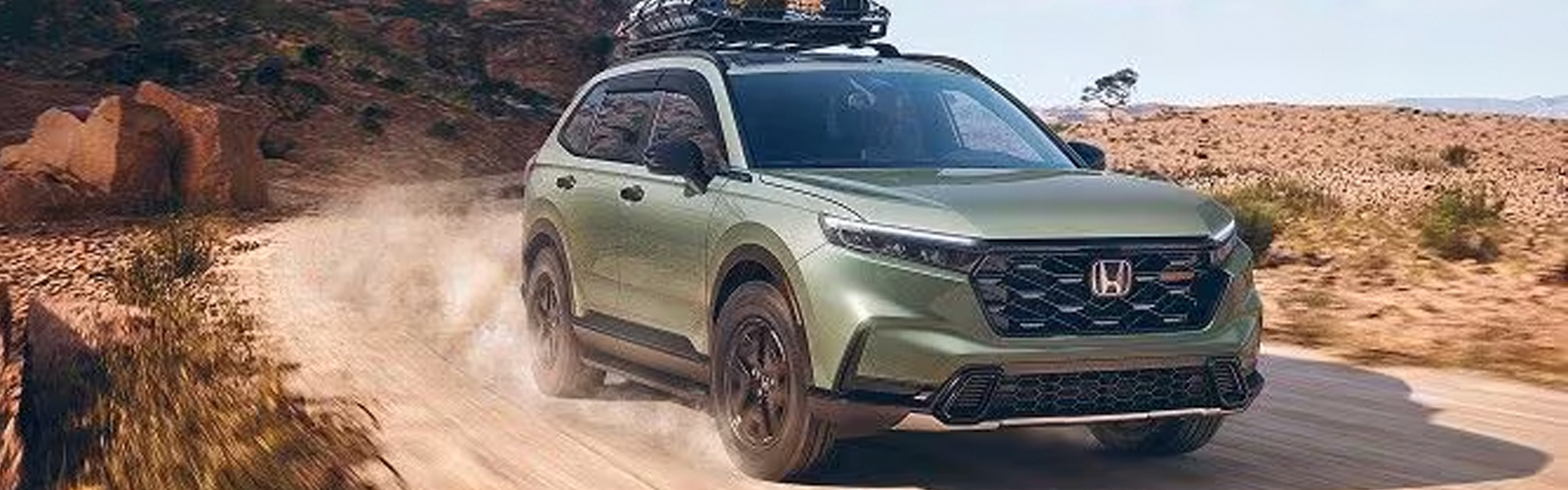 2026 Honda CR-V driving off-road with a roof rack.