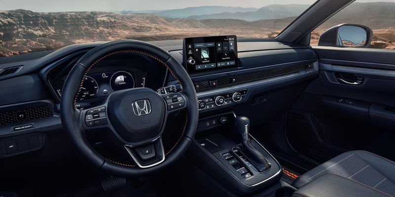 Interior view of the 2026 Honda CR-V showing the steering wheel and infotainment system.